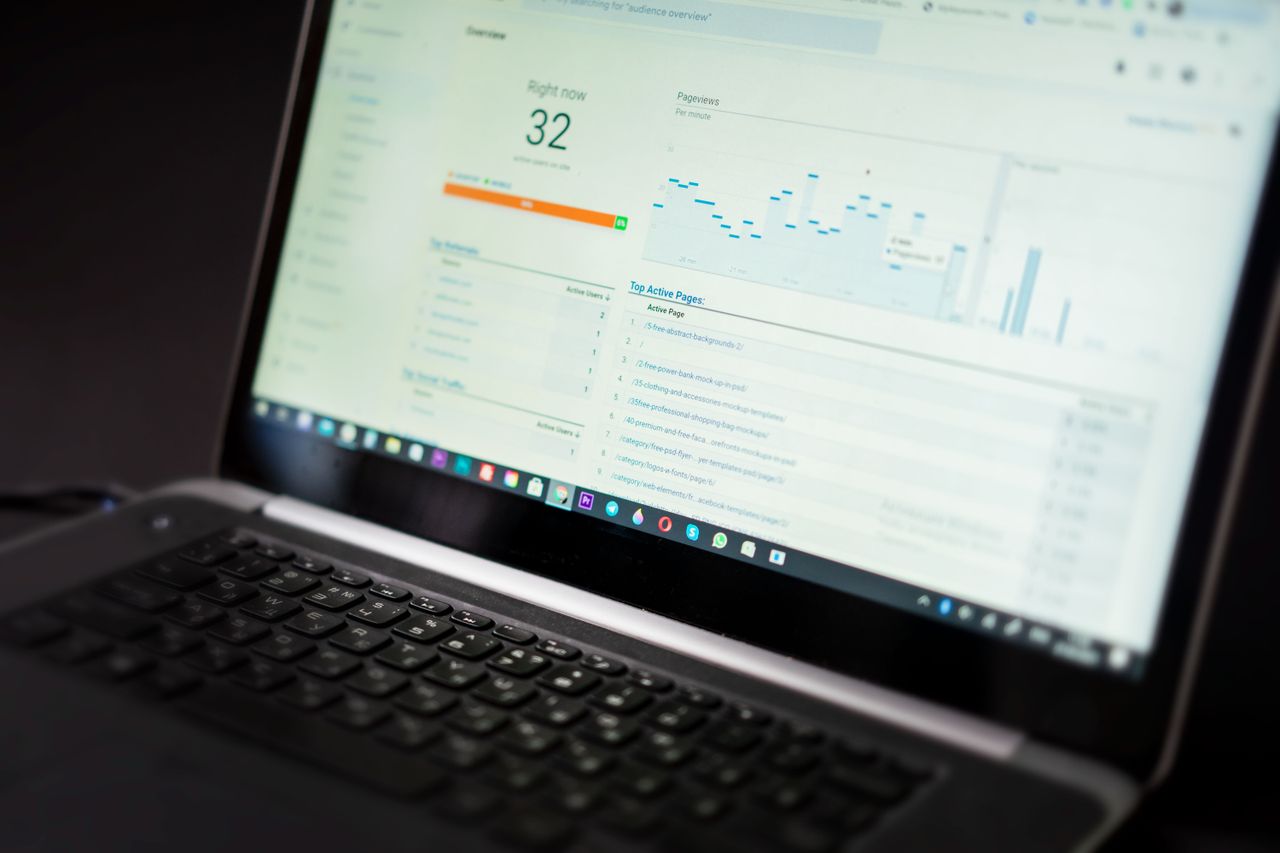 services-01 A laptop displaying an analytics dashboard with real-time data tracking and analysis tools.