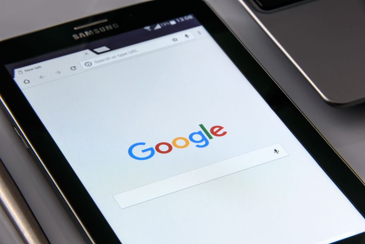 why-choose-us Close-up of a tablet displaying Googles search screen, emphasizing technology and internet browsing.